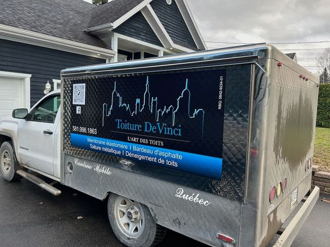 A dirty truck is parked in front of a house.