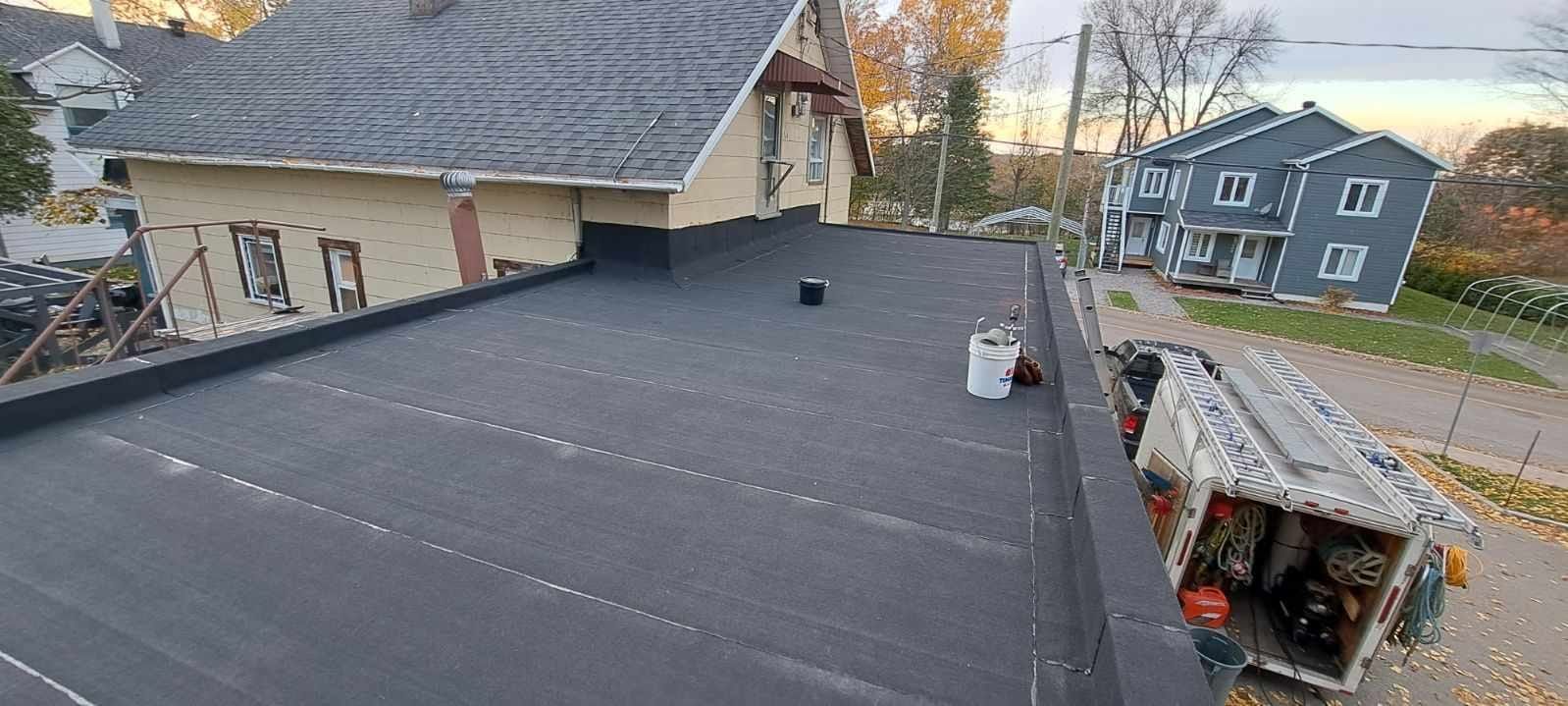 A man is working on the roof of a house.