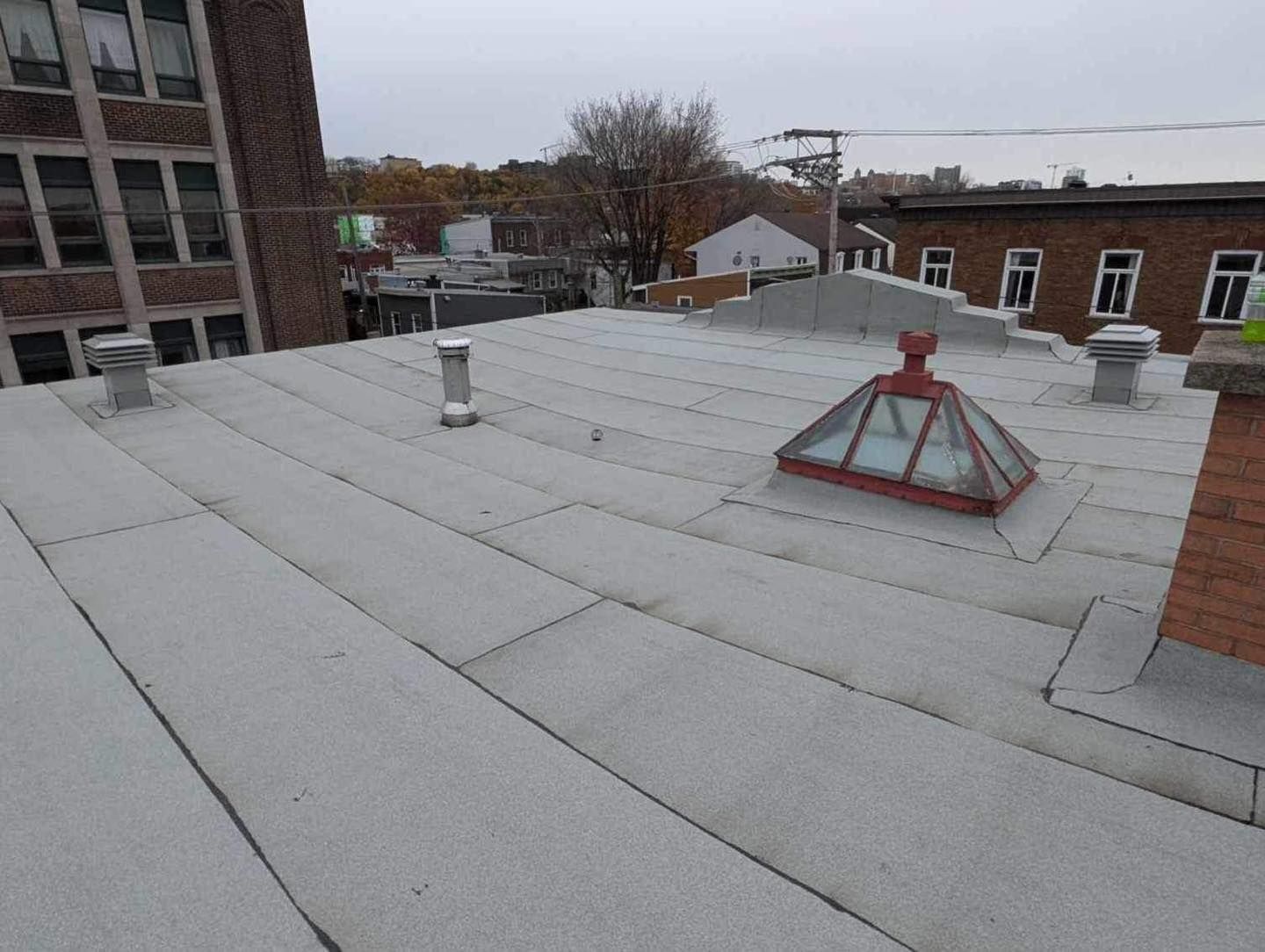 A white roof with a red dome on top of it