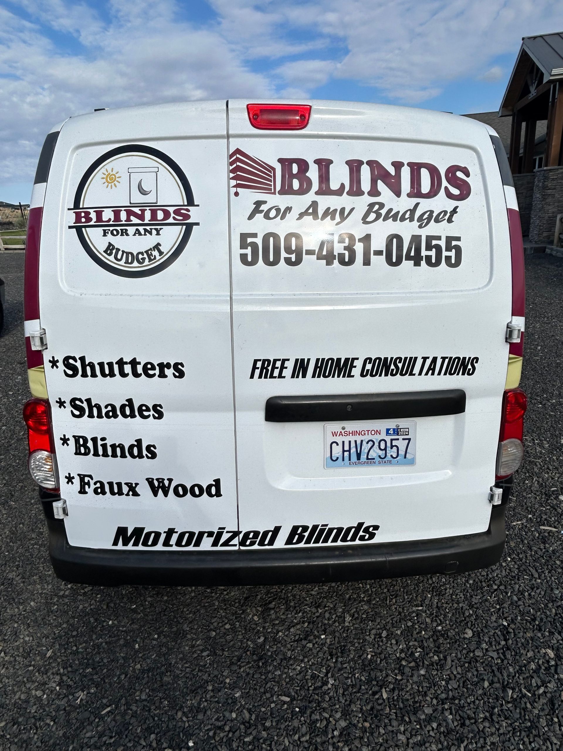 A living room with a couch and chairs and shutters on the windows