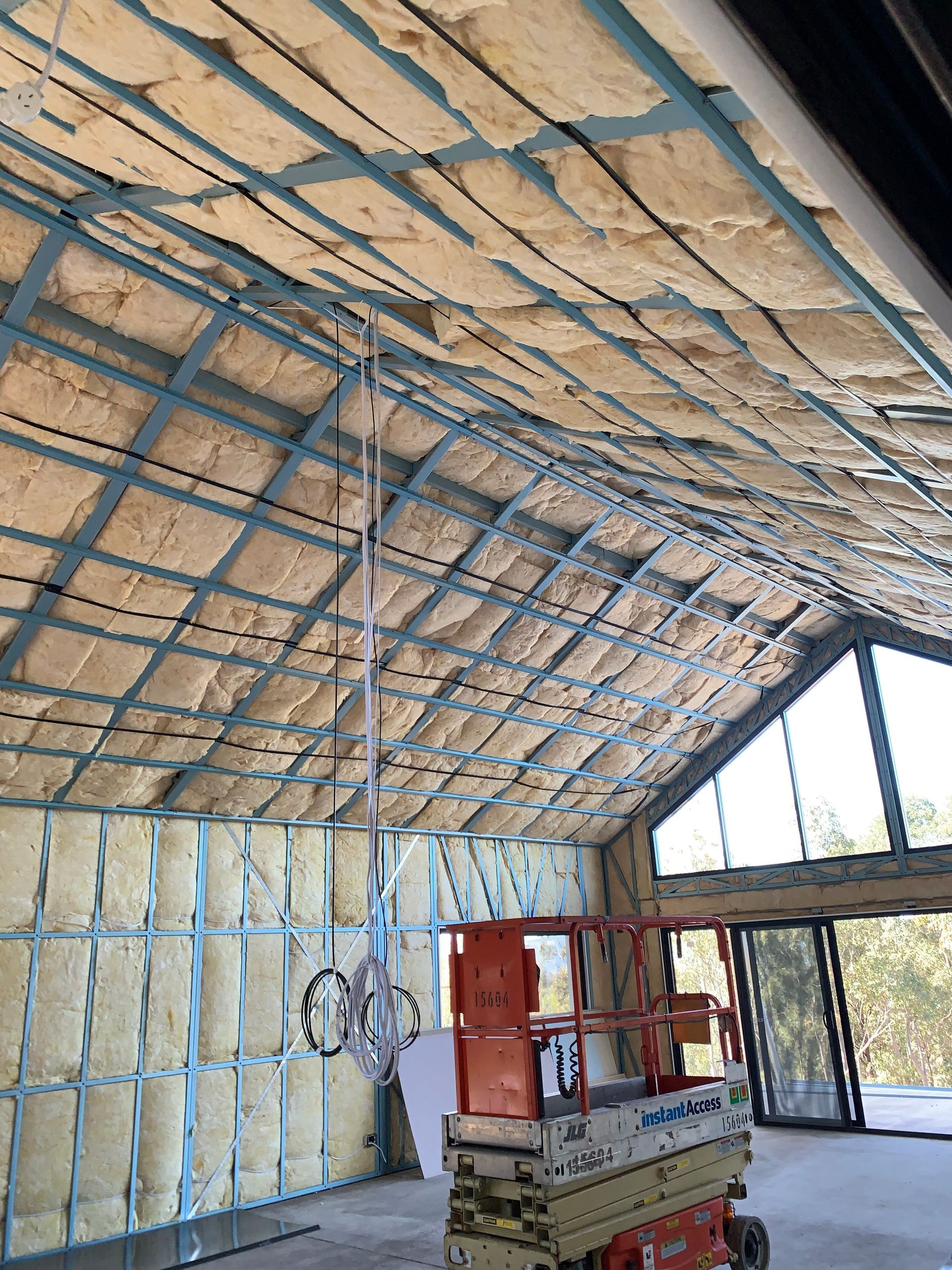 Completed insulation installation within walls and roof of new build.