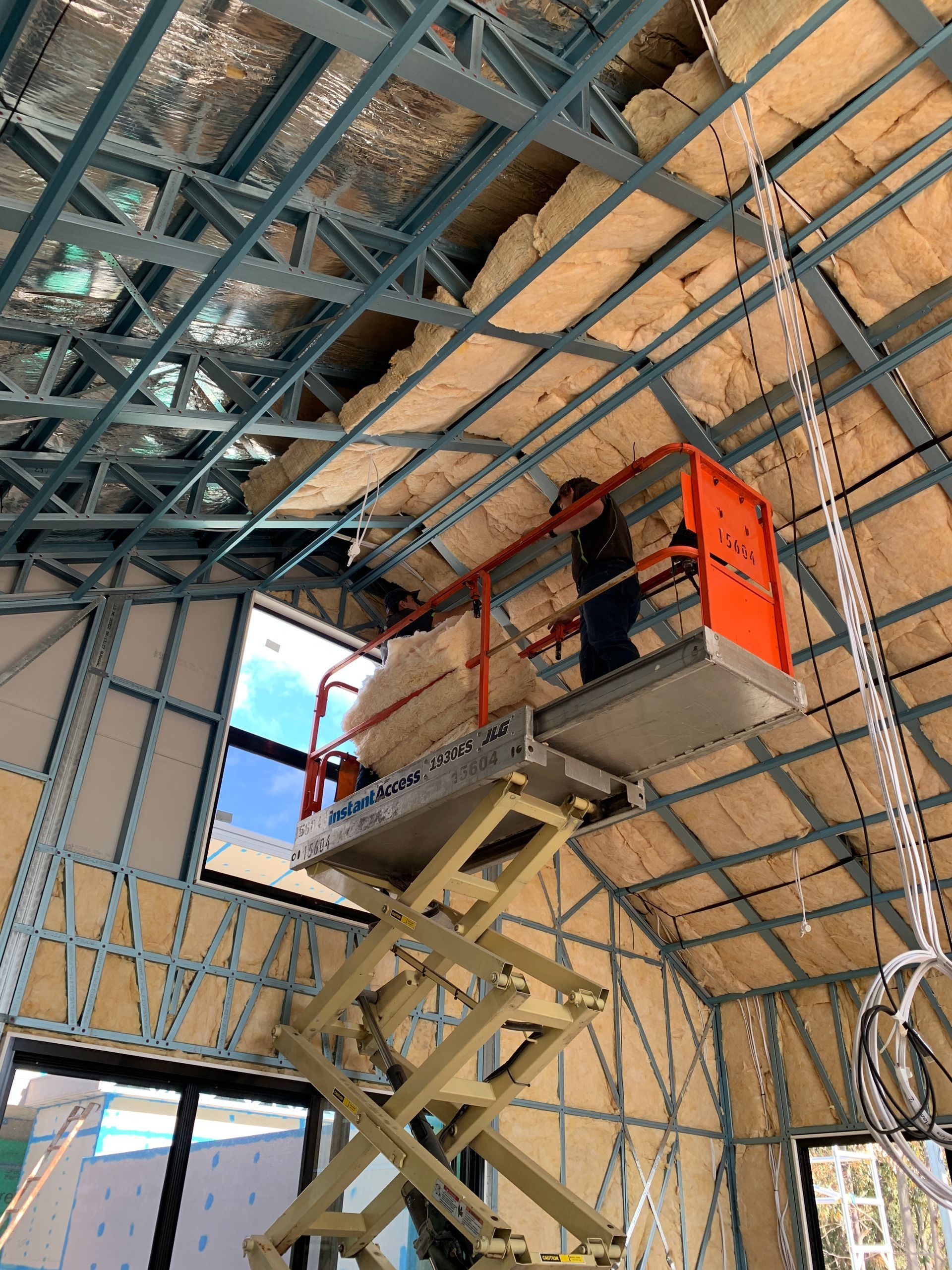 Insulation being installed in the walls of a newly built home.