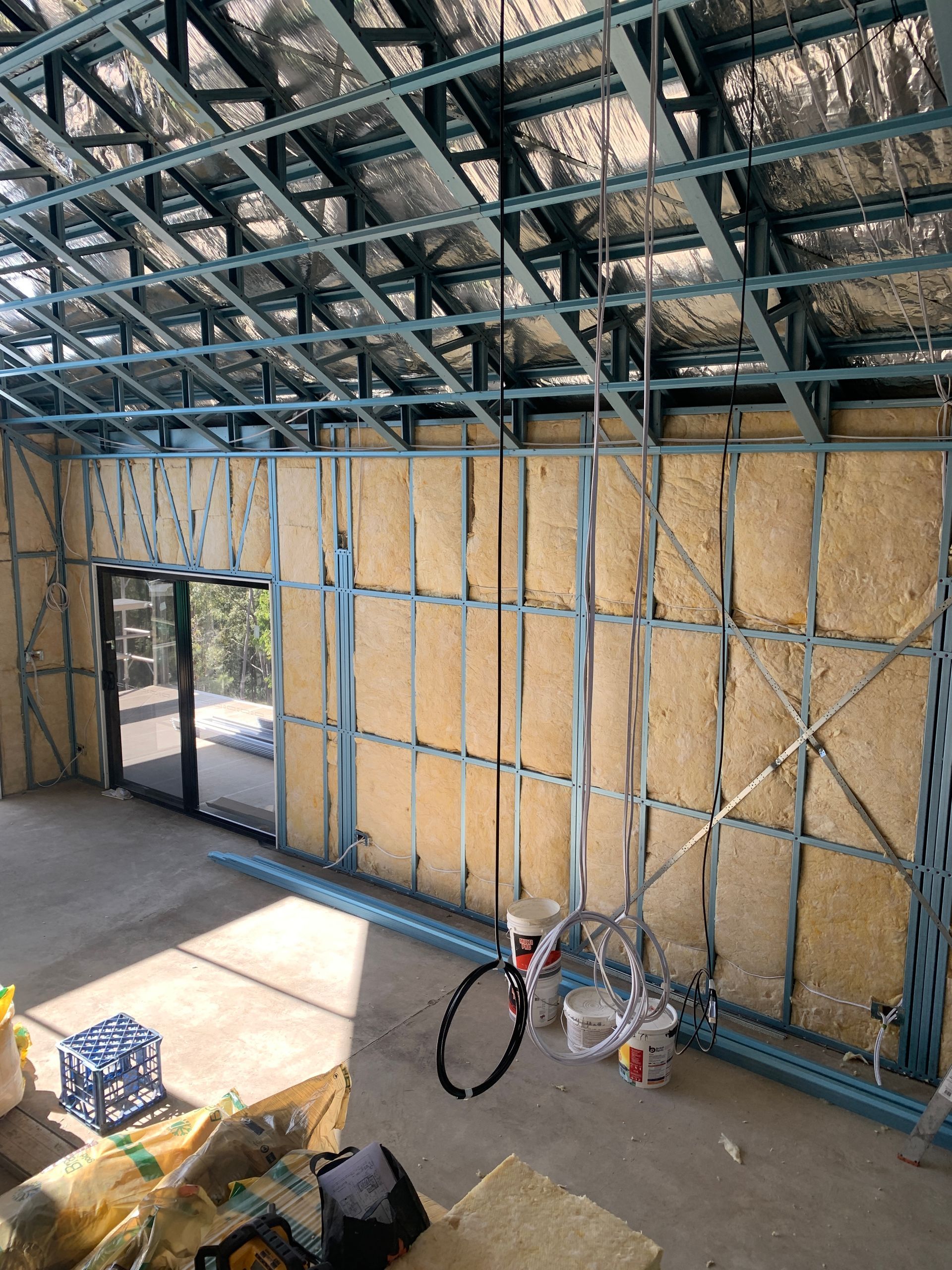 Insulation half way installed in the walls of a newly built home.