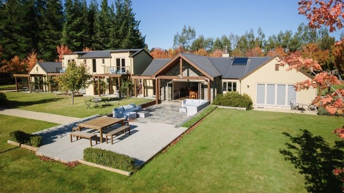 A large house with a large lawn in front of it
