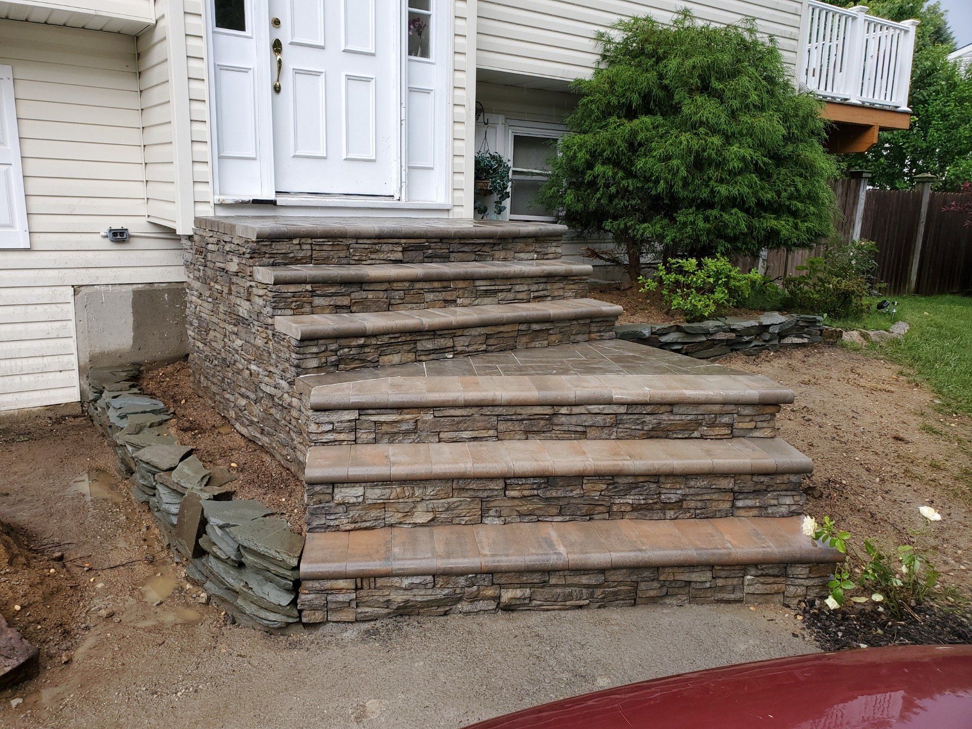 A set of stone steps leading up to the front door of a house