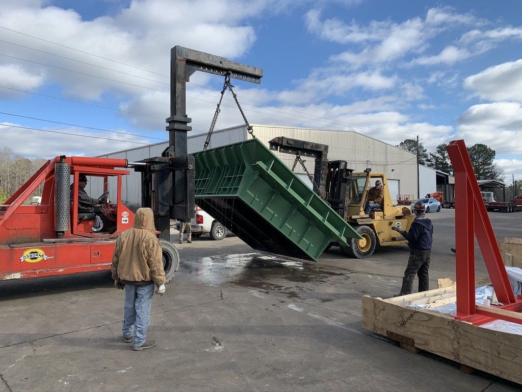 A yellow forklift is parked in a large warehouse