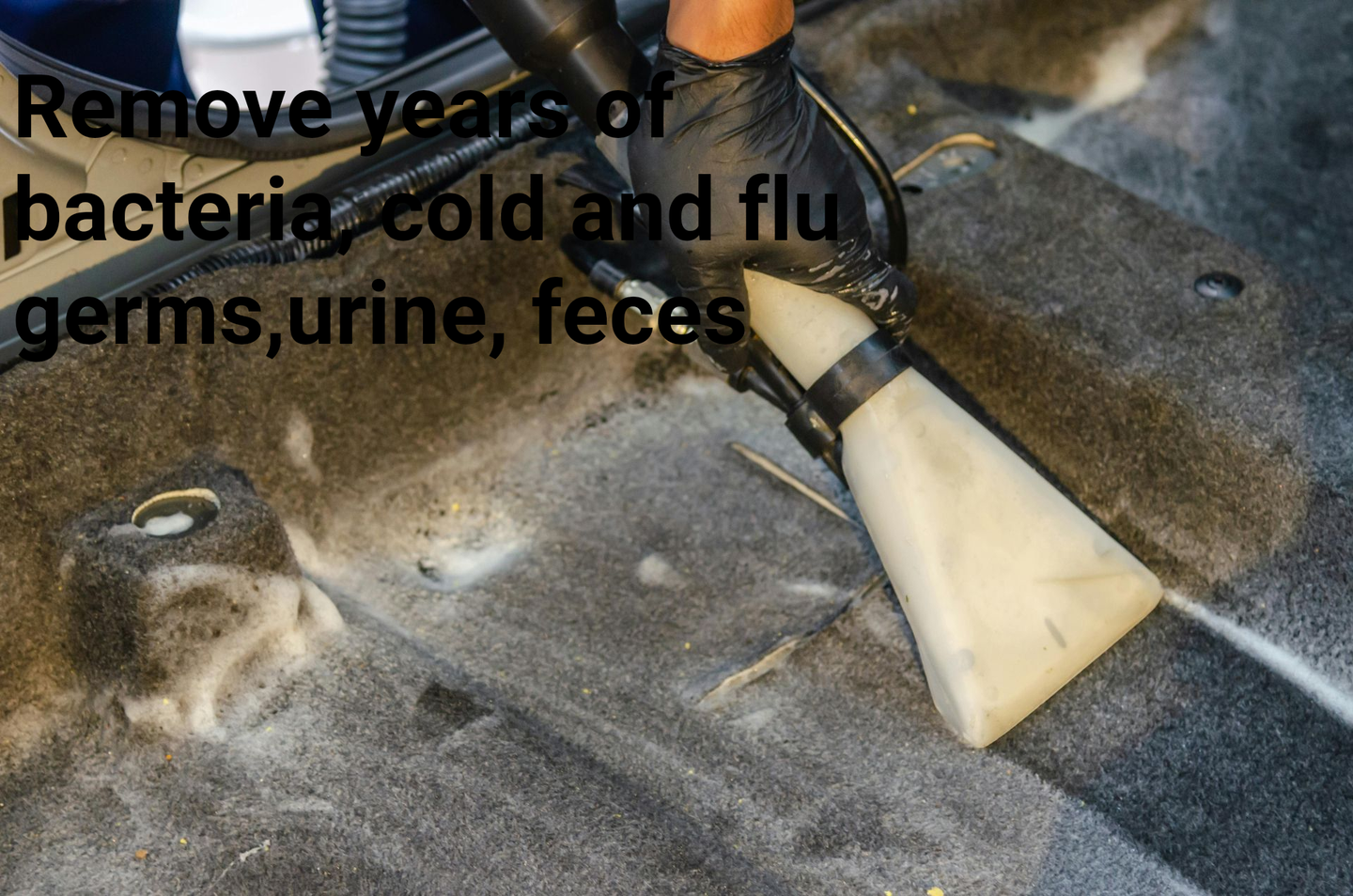 Cleaning a car's interior with a vacuum. Black gloves, text mentions germs, urine, feces.
