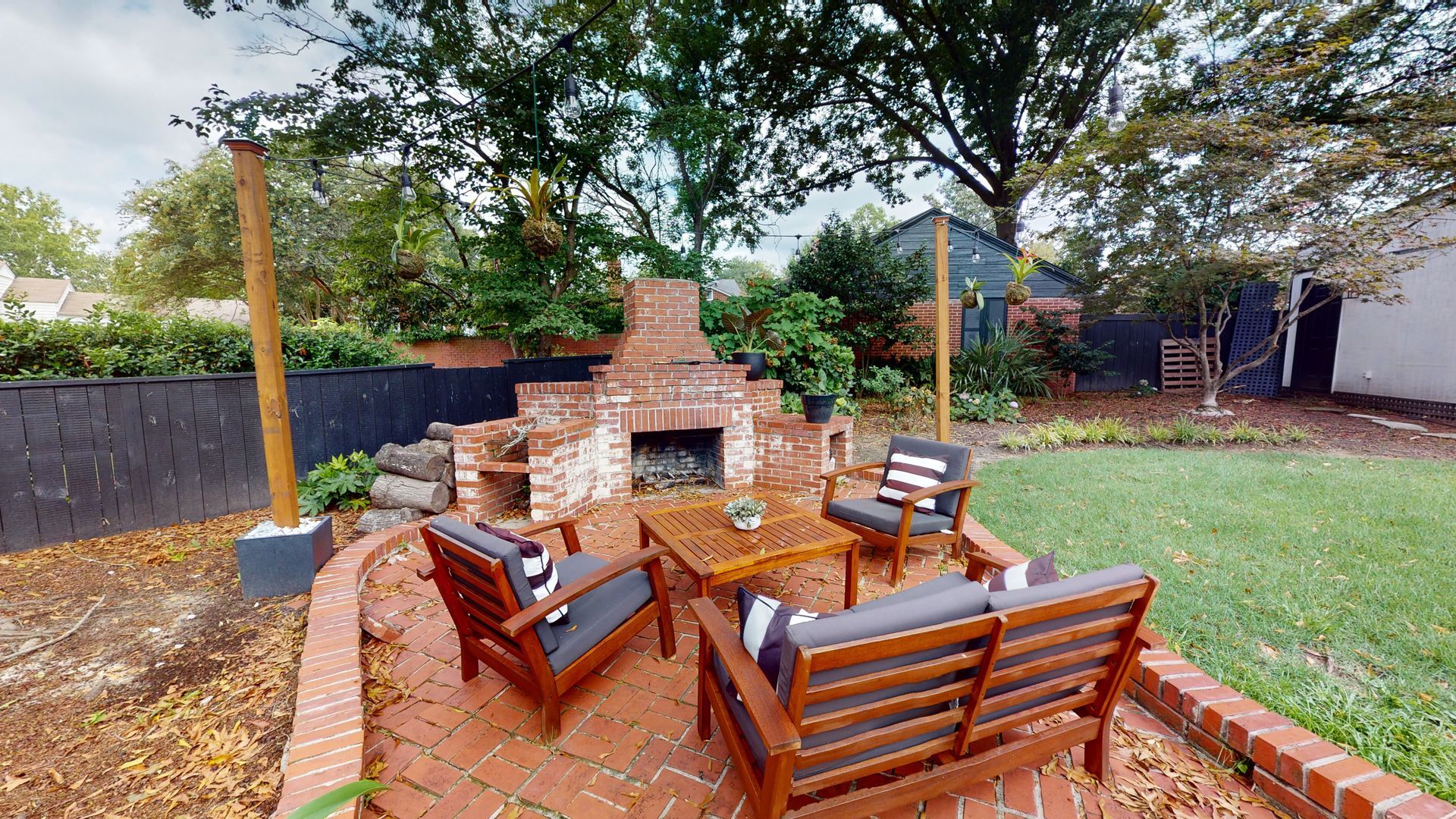 A living room with a couch , chairs , ottoman and a mirror