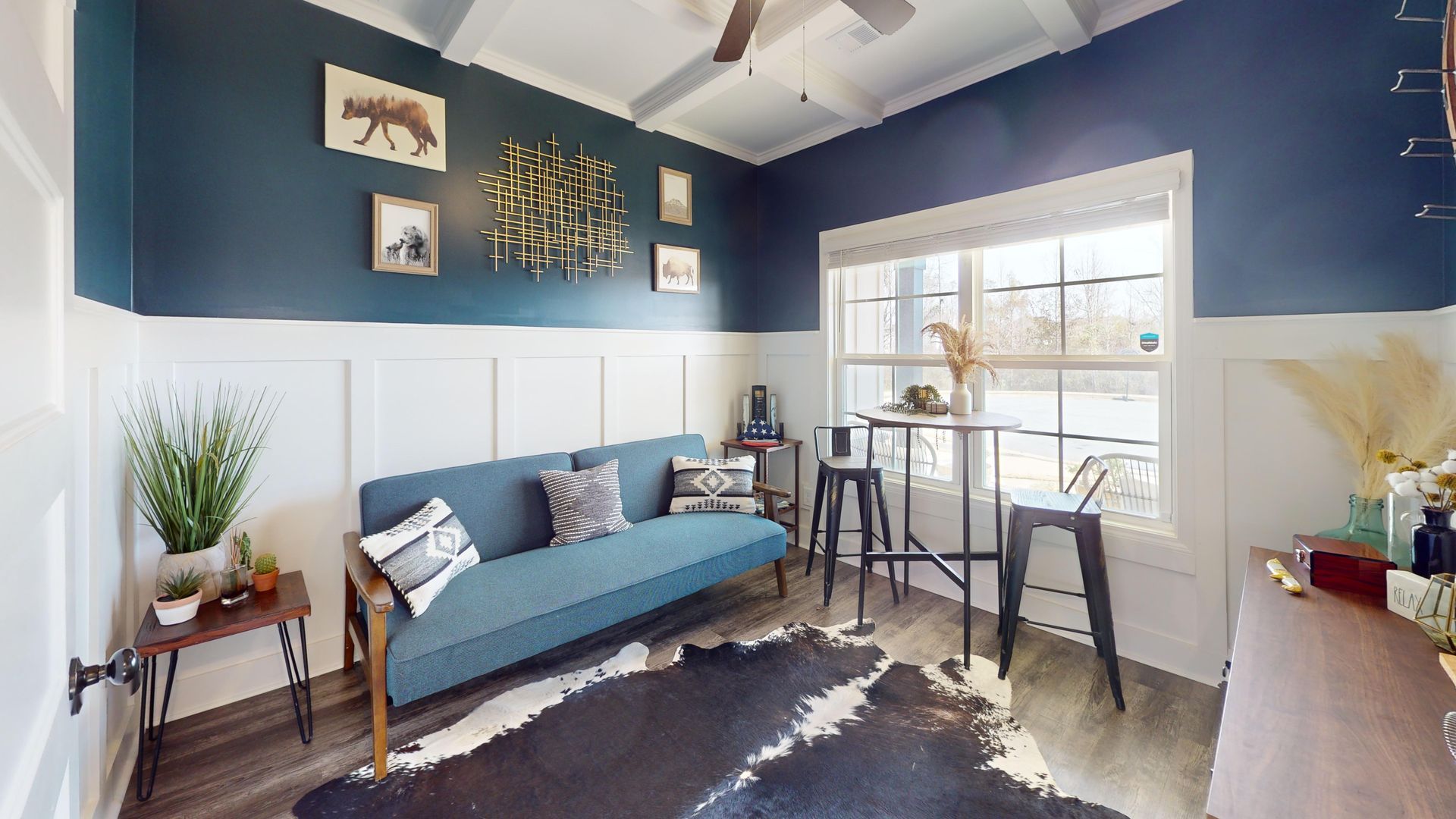 A dining room with a table and chairs and a wooden staircase.