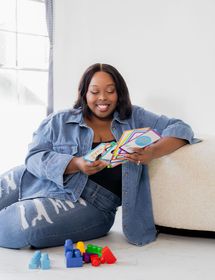 Anisha Angella looking at childrens playing cards