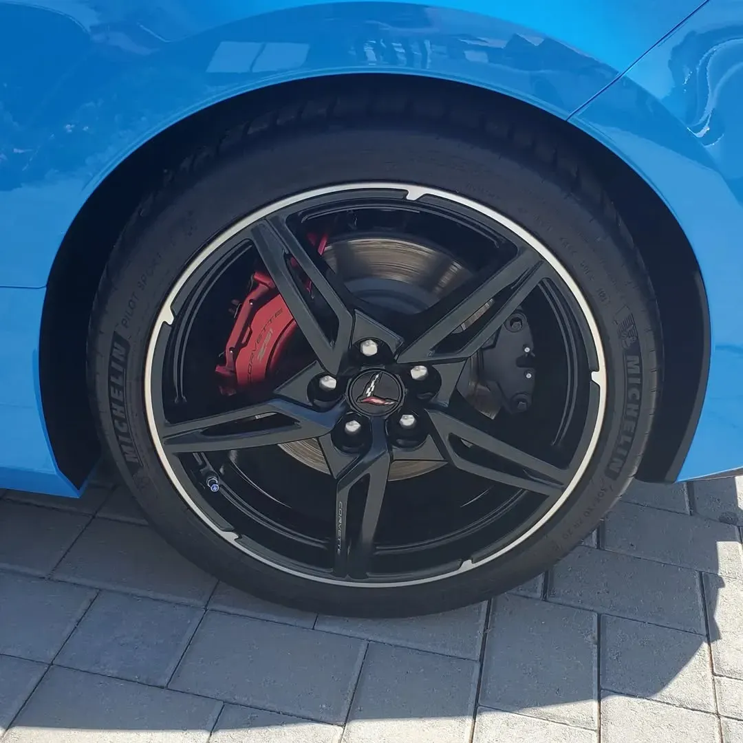 Blue BMW X3 SUV parked in front of a light-colored building.