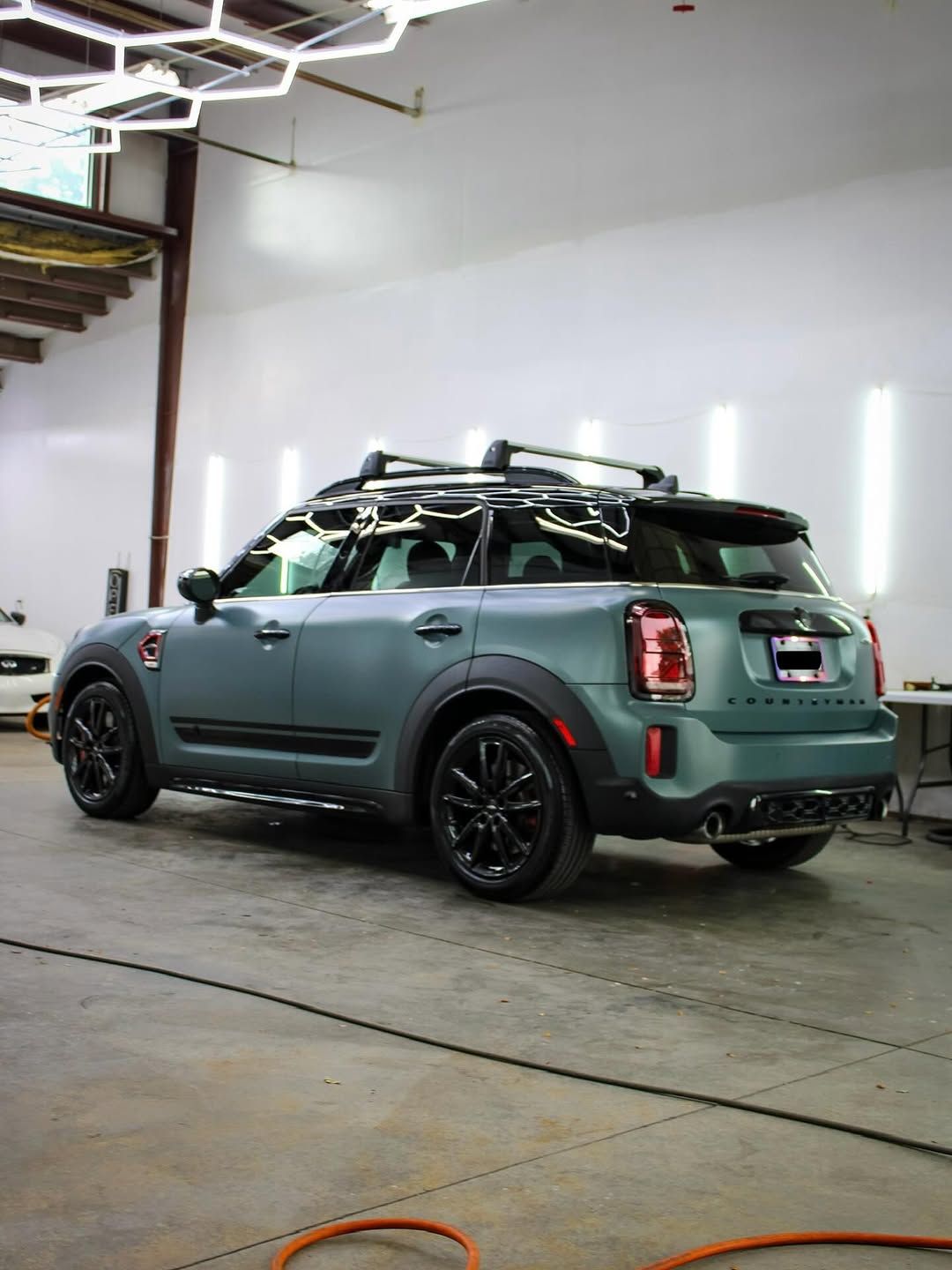 Blue BMW X3 SUV parked in front of a light-colored building.