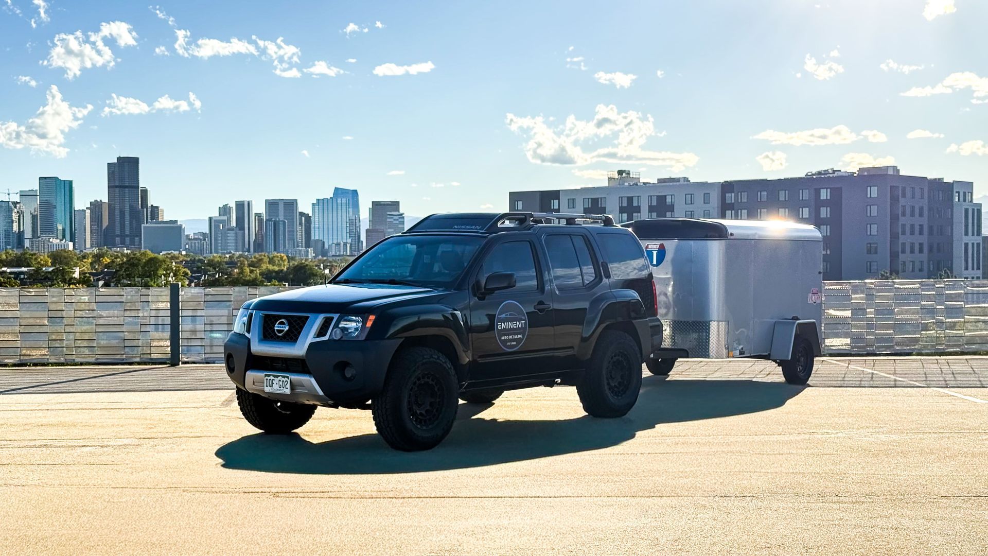 Headlight polishing: a person uses a power buffer on a car's headlight. The left side is clear, the right is hazy.