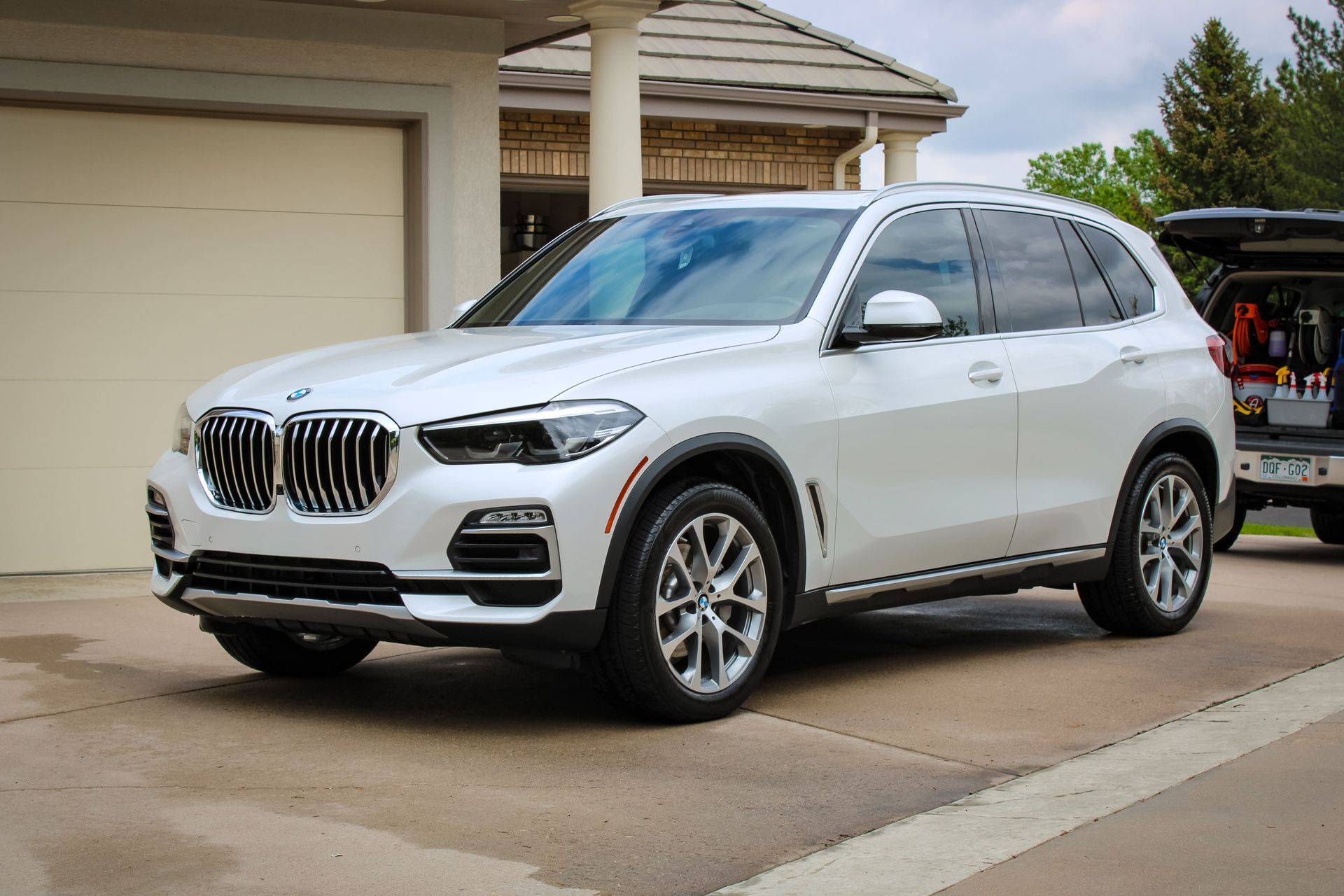 White BMW SUV parked in a driveway.