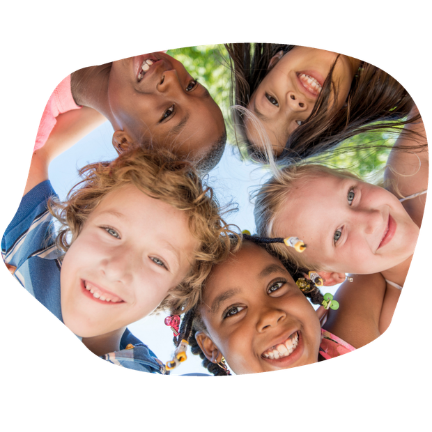Five diverse children smiling and looking down at the camera, forming a circle.