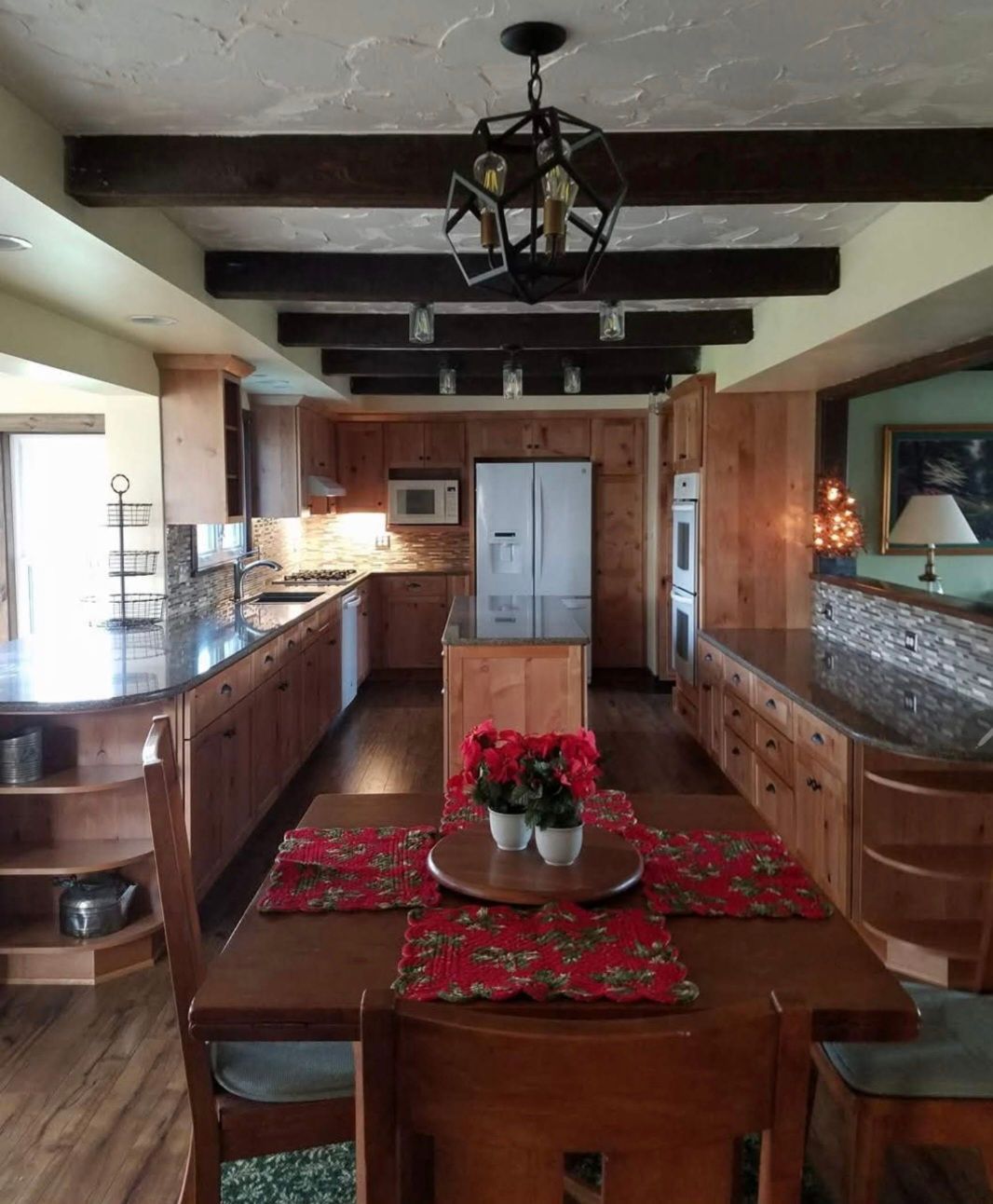 A kitchen with a table and chairs and a refrigerator