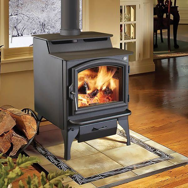 A wood stove is sitting on a tiled floor in a living room.