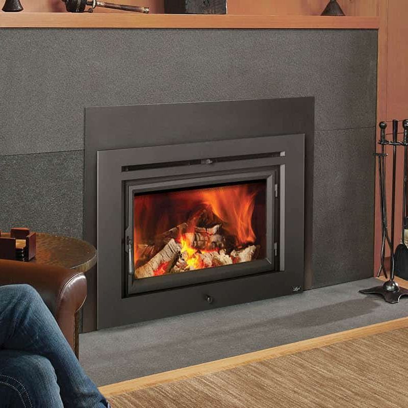 A fireplace with a person sitting in front of it