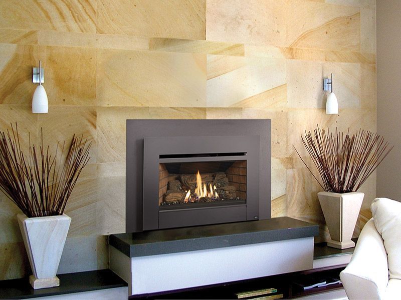 A living room with a fireplace and potted plants