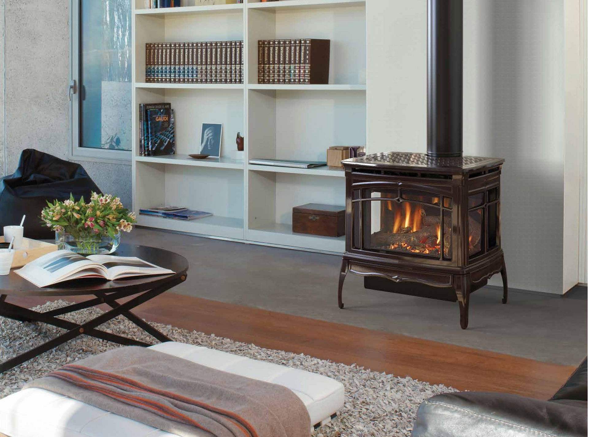 A living room with a wood stove and a coffee table