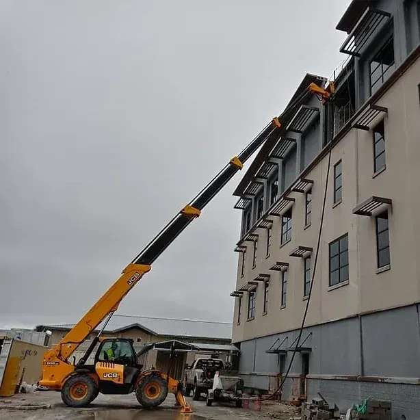 Using Crane for Repairing High Window — St. Augustine, FL — Reed Concrete Pumping LLC