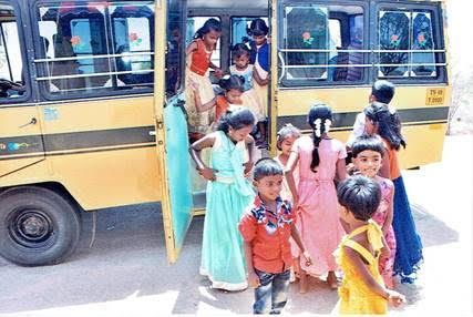 Children boarding and gathering around a yellow school bus on a sunny day
