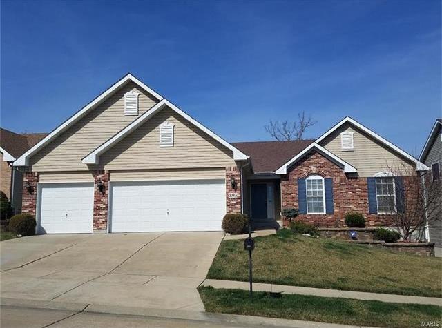 A large brick house with two white garage doors