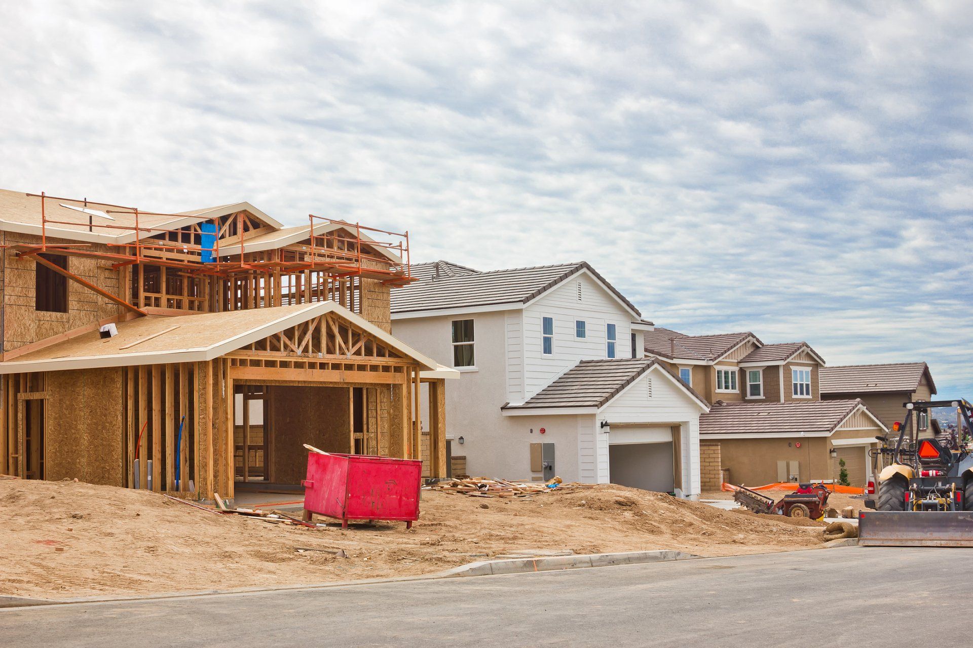A row of houses are being built in a residential area