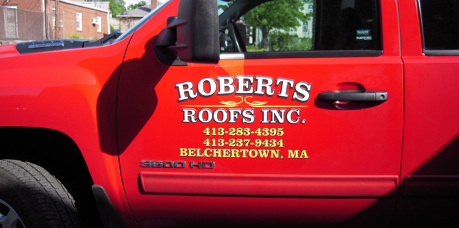 Roberts Roofs Inc side of their work truck in Belchertown, MA