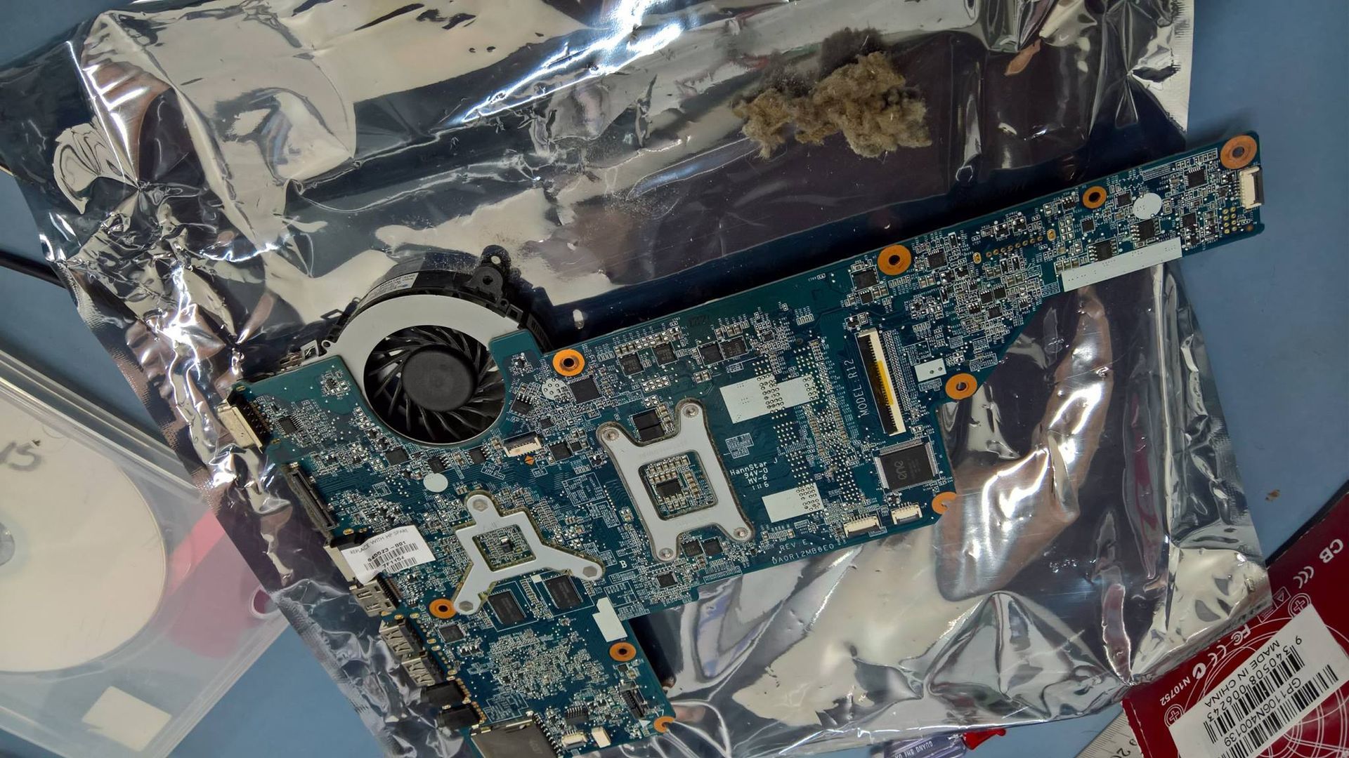 Laptop Motherboard on Metallic Foil, With a Fan and Chips — Tech Aid In Moffat Beach, QLD