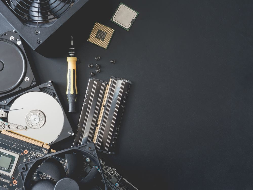 Computer Parts Laid Out on a Dark Surface, Including Hard Drives — Tech Aid In Moffat Beach, QLD