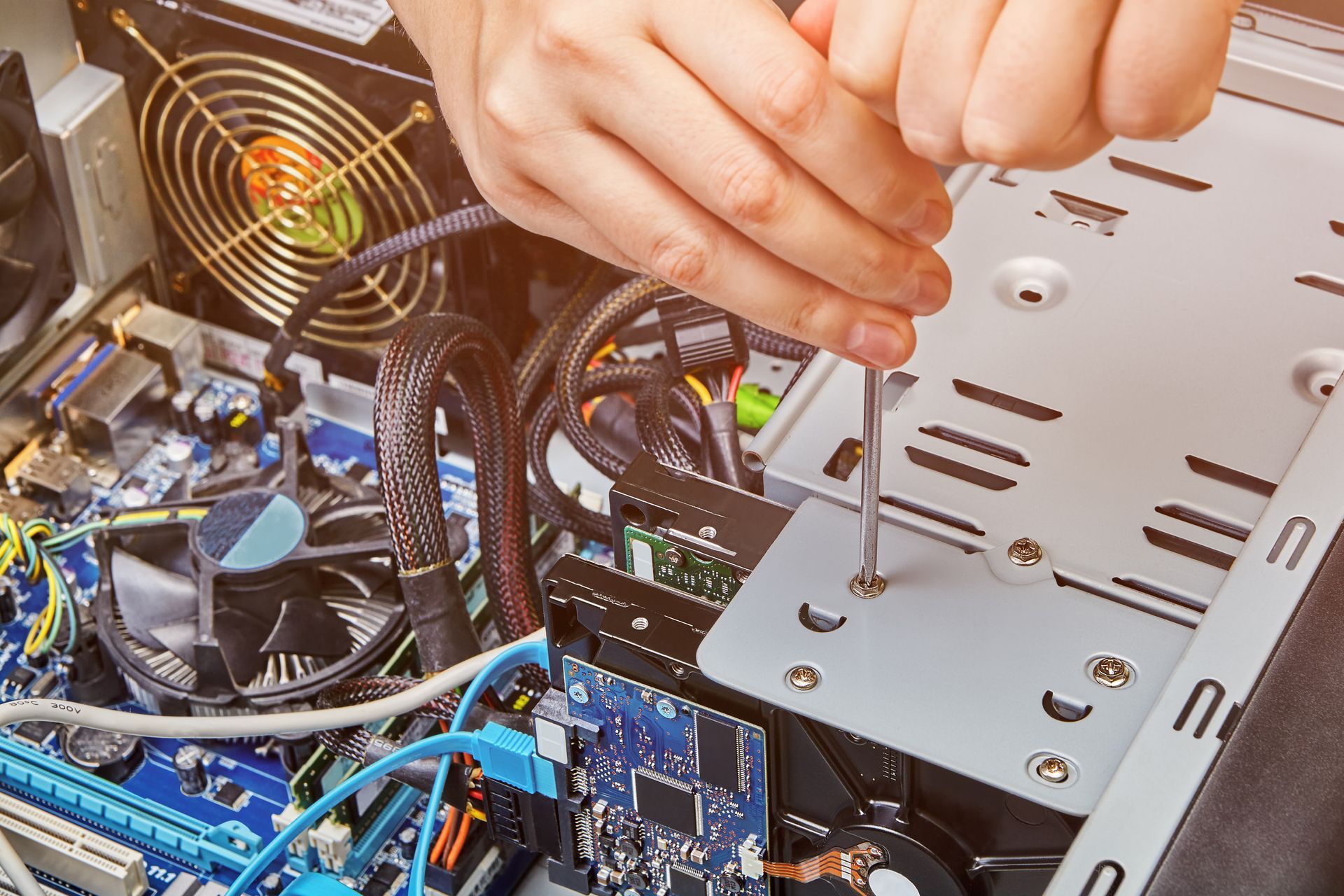 Hands Using a Screwdriver to Assemble a Computer's Internal Components Inside a Case — Tech Aid In Moffat Beach, QLD