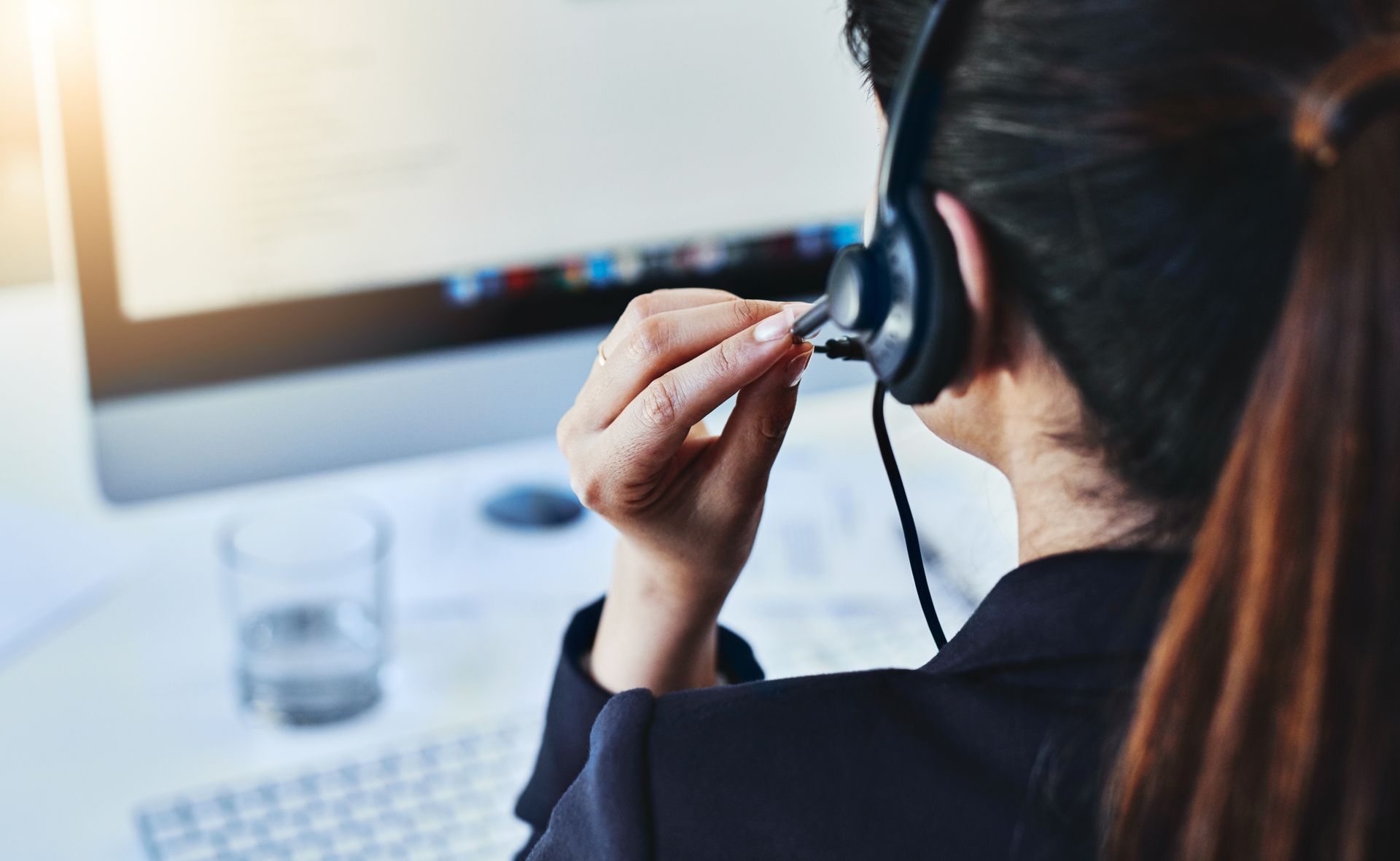 People in an Office on the Phone; One Man Smiles, Holding a Paper — Tech Aid In Bribie Island, QLD