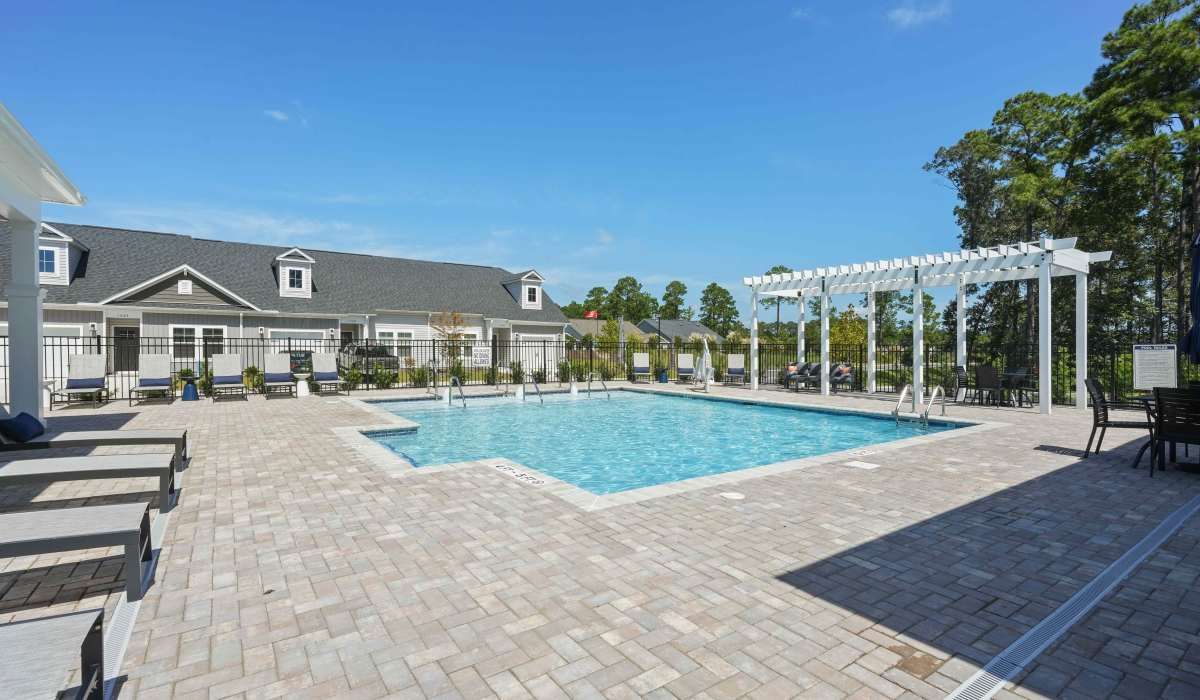 Swimming pool with lounge chairs at Reve Park Ridge in Little River, South Carolina