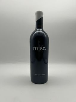 A bottle of wine with a white flower on the label.