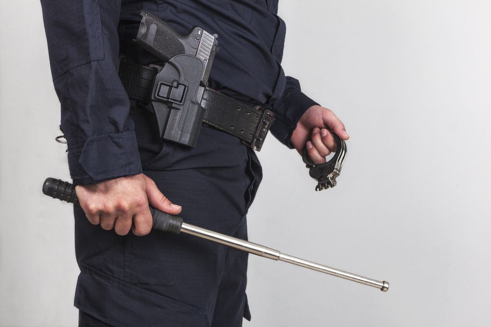 Policeman With Gun, Handcuff And Iron Baton — ASAP Pest Control in Mount Gravatt, QLD