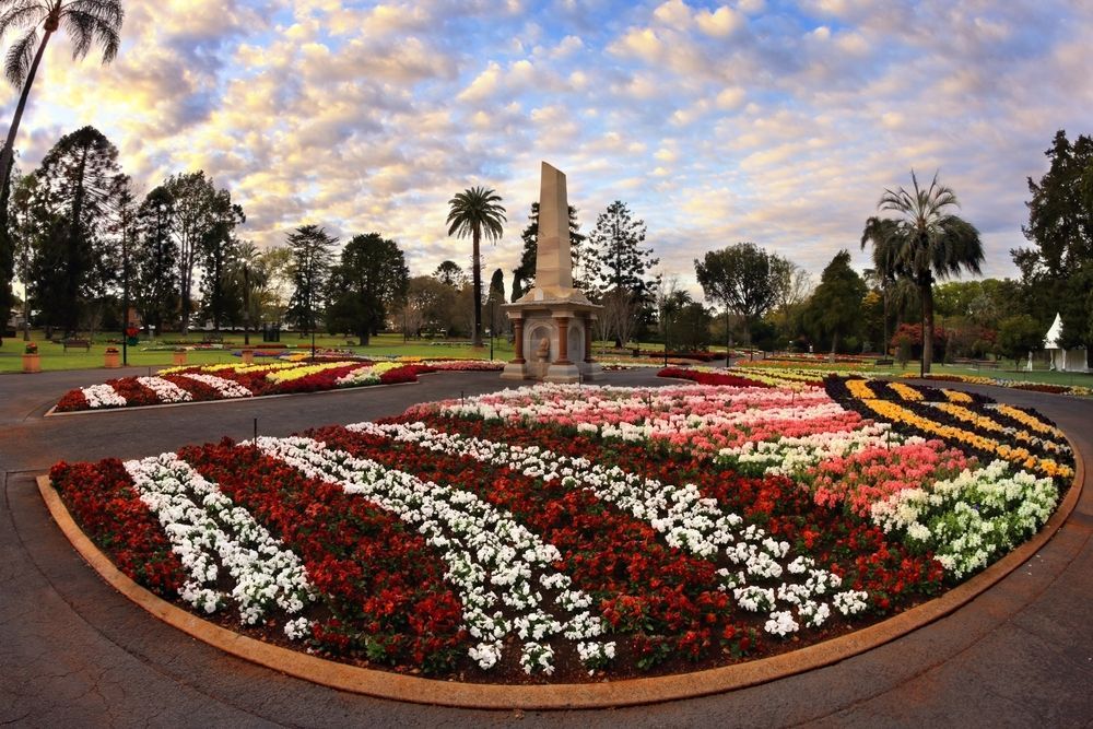 A Circle Of Flowers In A Park With A Statue — ASAP Pest Control in Brisbane South, QLD