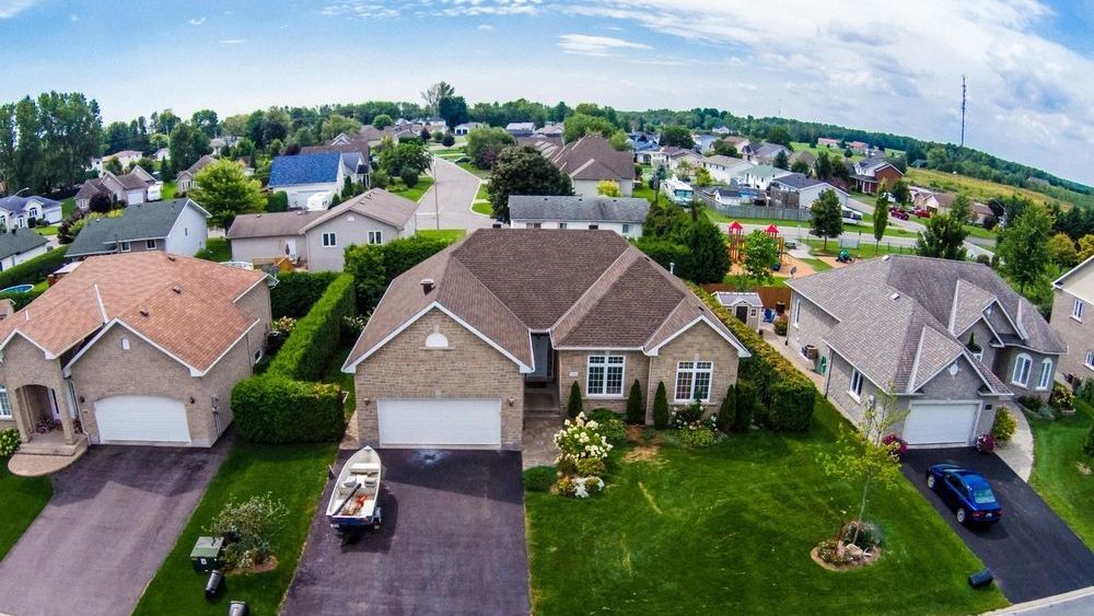 An Aerial View Of A Residential Neighborhood With Houses And Garages — ASAP Pest Control In Ipswich, QLD