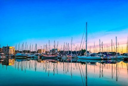 A Row Of Boats Are Docked In A Harbor At Sunset — ASAP Pest Control in Ipswich, QLD