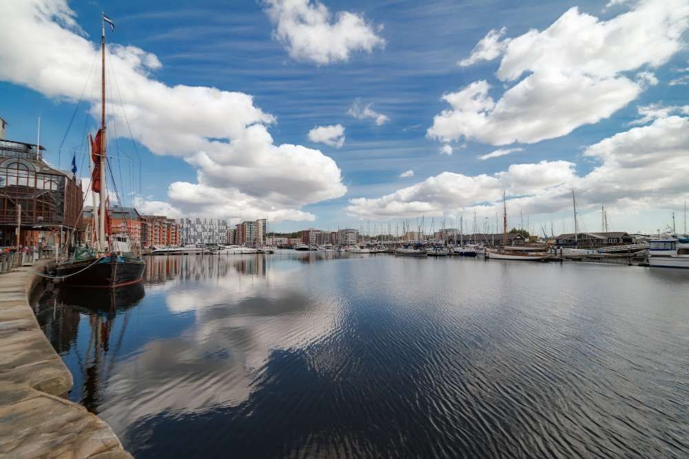 A Harbor With Boats Docked And A Blue Sky With Clouds Reflected In The Water — ASAP Pest Control in Ipswich, QLD