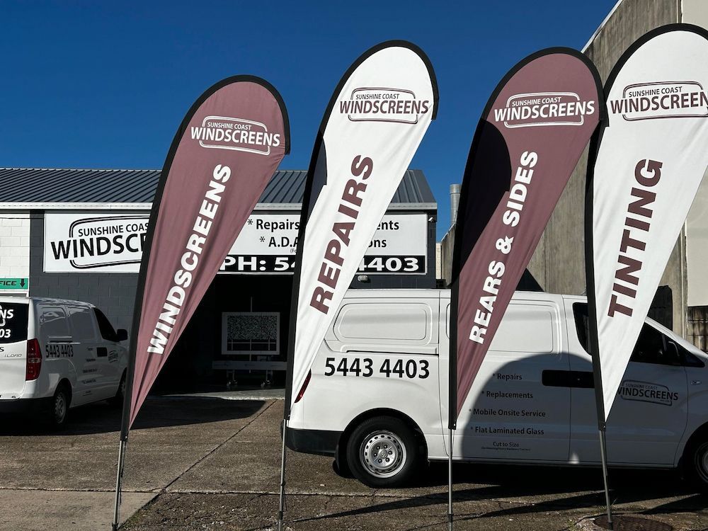 A Windscreen Repairs Van is Parked in Front of a Building — Sunshine Coast Windscreens In Caloundra, QLD