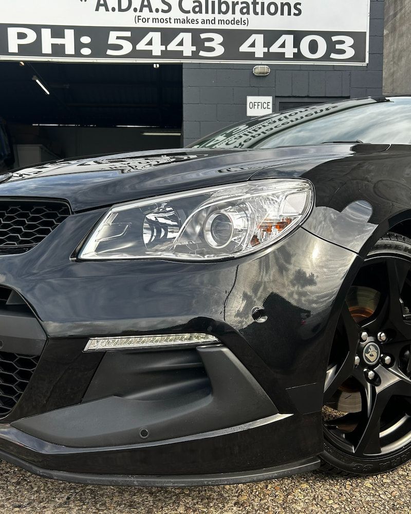 A Black Car is Parked in Front of a Building — Sunshine Coast Windscreens In Maroochydore, QLD