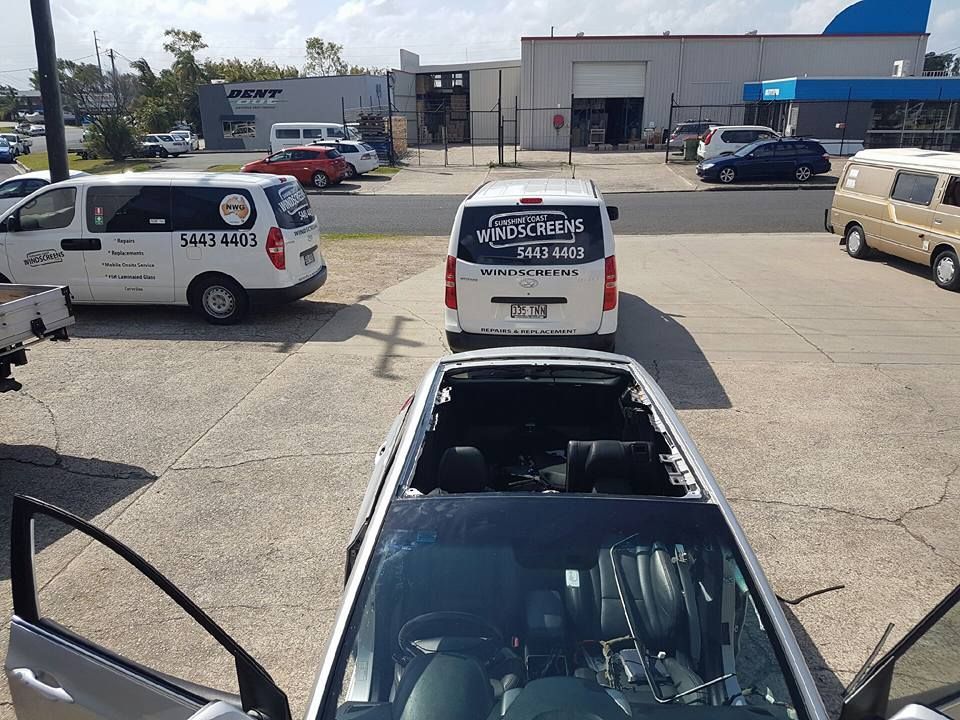 A Car With a Broken Windshield is Parked in a Parking Lot — Sunshine Coast Windscreens In Buderim, QLD