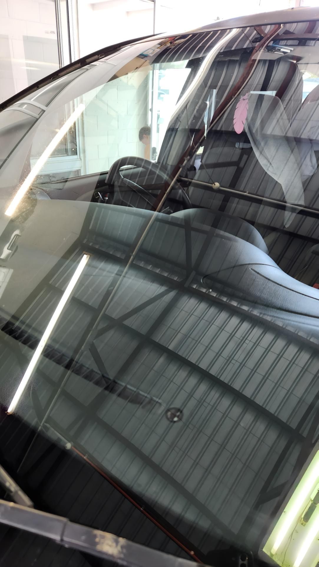 Windshield of a Car With a Crack, Reflecting a Metallic Building Interior— Sunshine Coast Windscreens In Buderim, QLD