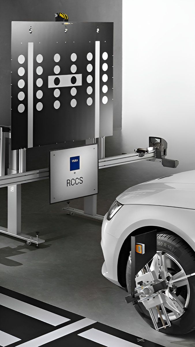A White Car is Being Adjusted by a Machine in a Garage — Sunshine Coast Windscreens In Buderim, QLD