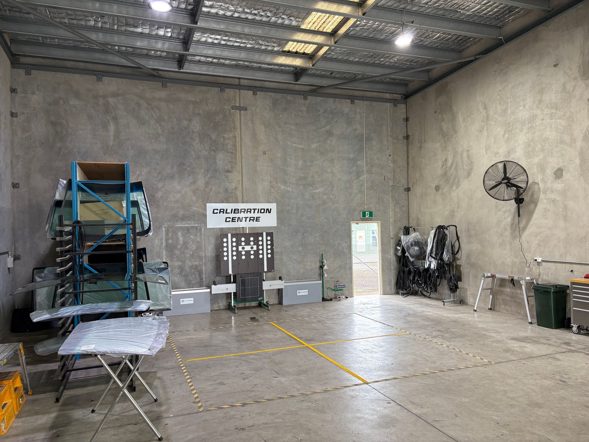 A large empty warehouse with a sign on the wall that says ' warehouse ' on it.