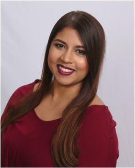 A woman in a red shirt is smiling for the camera.
