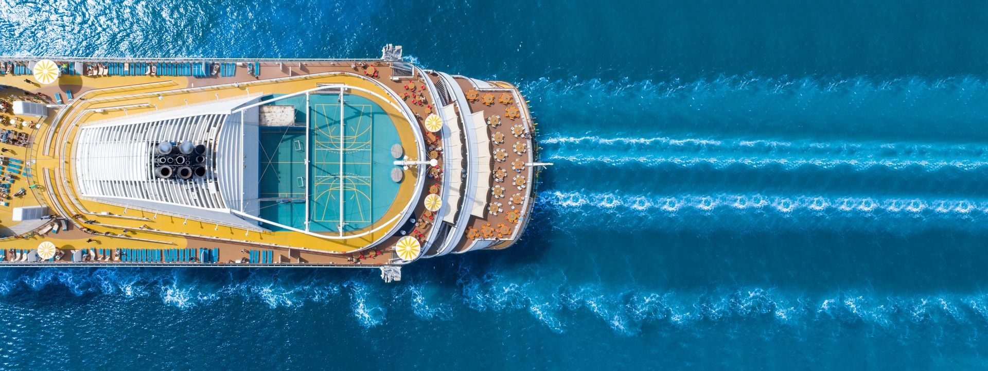An aerial view of a cruise ship floating on top of a body of water.