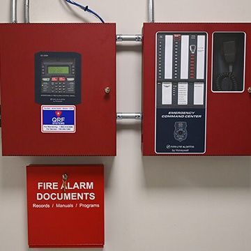 A red box with a sign that says fire alarm documents