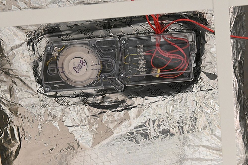 A close up of a device sitting on top of a piece of foil.